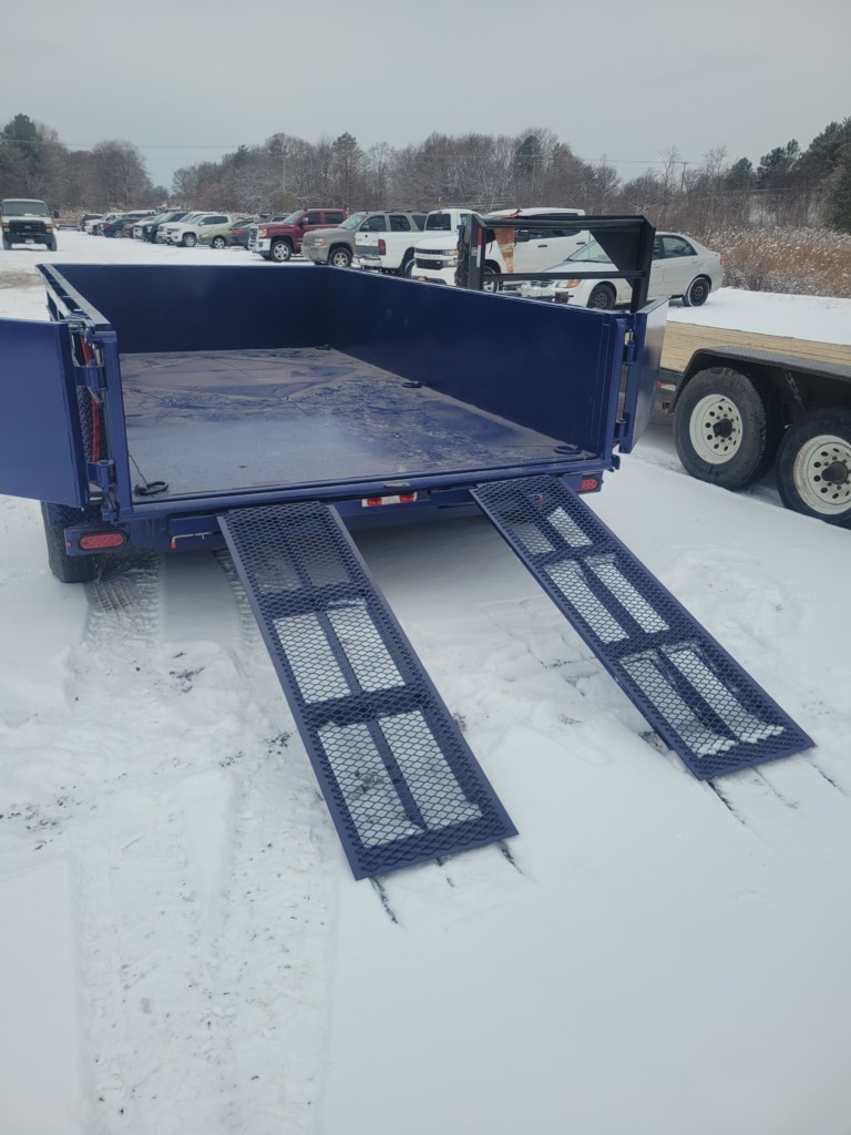 General Welding & Fabricating’s blue MSA 6-ton dump trailer displayed in a Memorial Day sale ad, emphasizing its heavy-duty build and special $12,000 price offer.