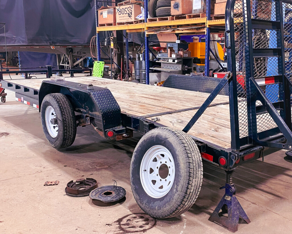 Equipment Trailer getting a routine inspection on the running gear.