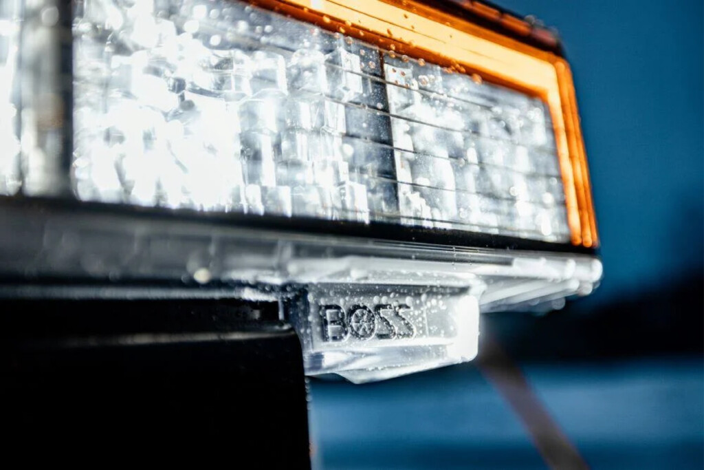 BOSS SL4 LED Headlights illuminating a snowy Buffalo road at night. These ultra-bright, durable headlights provide sharper beams and enhanced visibility for plow operators, ensuring safer and more efficient snow removal during Western New York’s harsh winter conditions. Built-in turn signals and warning lights improve road safety in heavy storms.