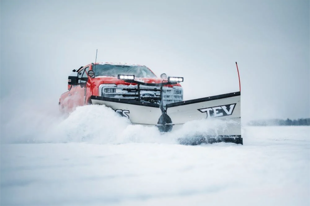 BOSS TEV Trip-Edge V-Plow clearing heavy snow on a Buffalo street. The plow’s rigid moldboard maximizes snow stacking, while the trip-edge design absorbs impact from hidden obstacles. Engineered for Western New York’s toughest winters, this durable V-plow ensures smooth and efficient snow removal for both urban and rural areas.