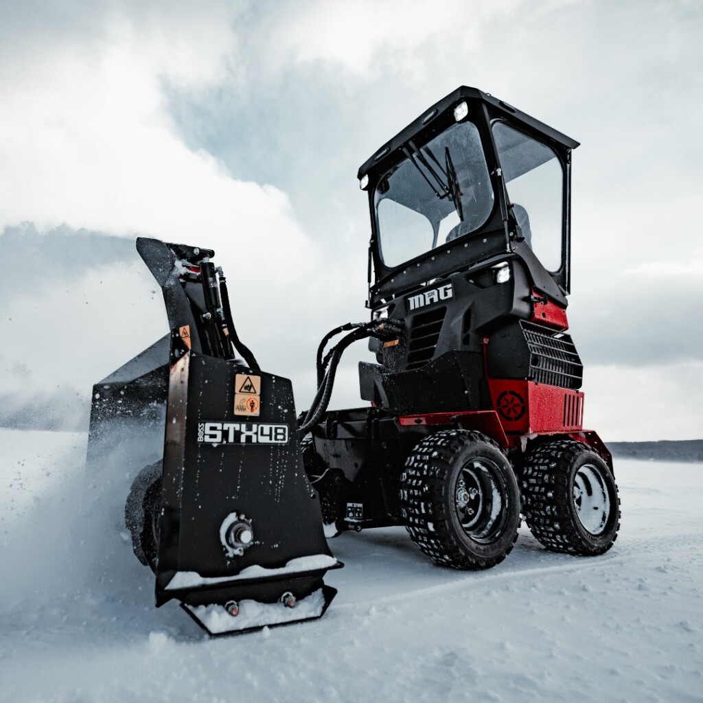 SR MAG Cab Attachment featuring enclosed windshield, side panels, and roof with utility lights for winter snow removal.